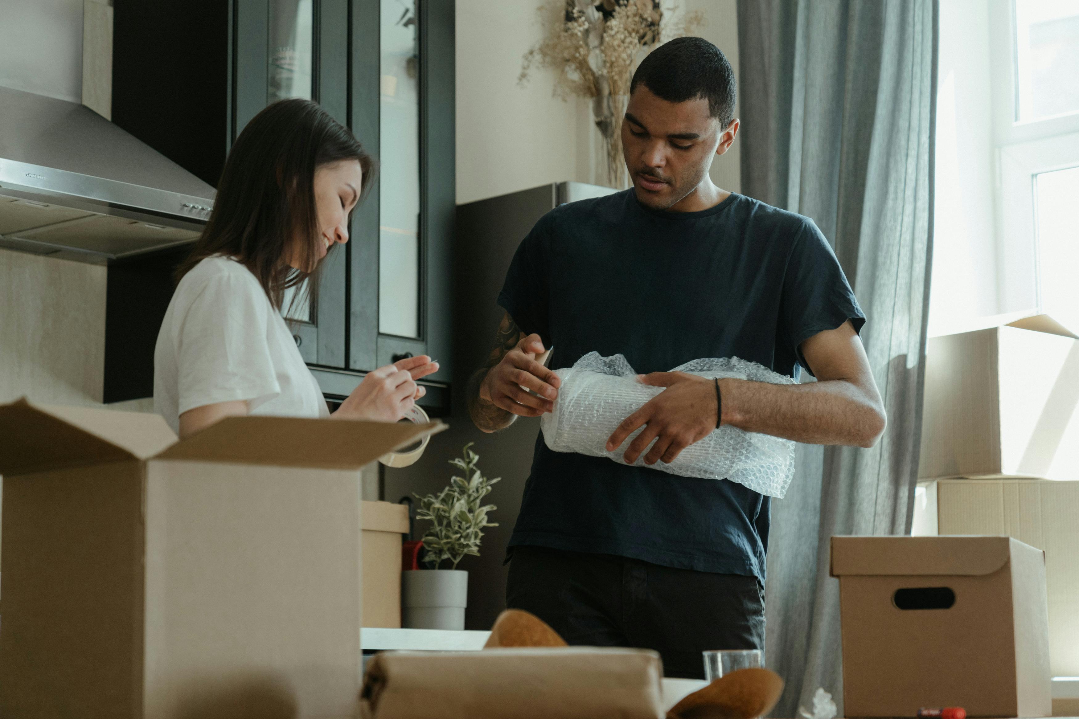 Couple packing to move house