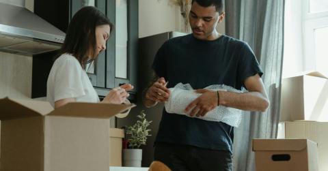 Couple packing to move house 